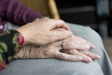 Elderly hands in lap